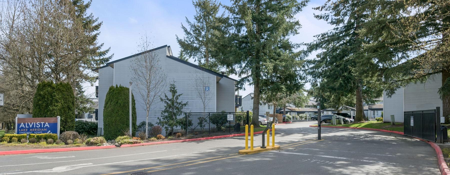 a road with trees and a building