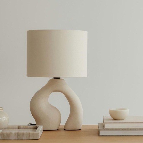 a lamp, stack of books, and decor