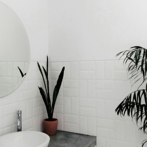 a bathroom with a round mirror